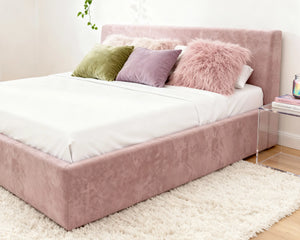 # Front view of O2 Soft Frame Bed in Promethium Pink, highlighting its smooth, velvet-like fabric and clean, minimalist design.