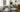 modular sofa on a living room, with plants, pillows, art on the wall and furnitures 